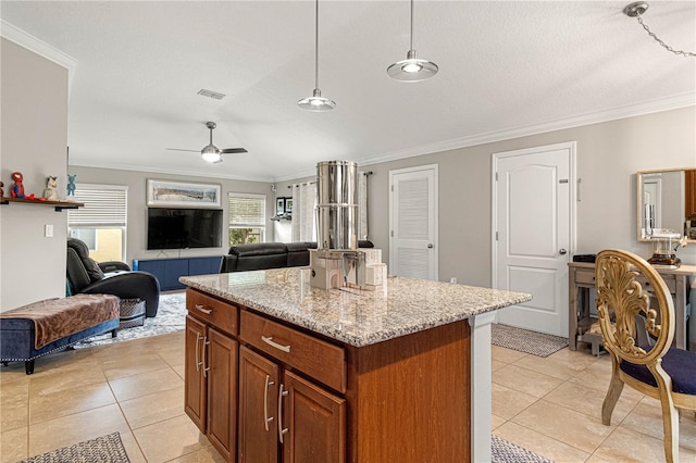 kitchen with open floor plan, light tile patterned floors, visible vents, and crown molding