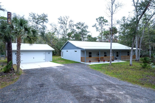 ranch-style home featuring a porch and a garage