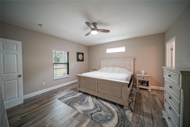 bedroom featuring a textured ceiling, ceiling fan, and dark hardwood / wood-style floors