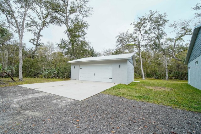 garage featuring a lawn