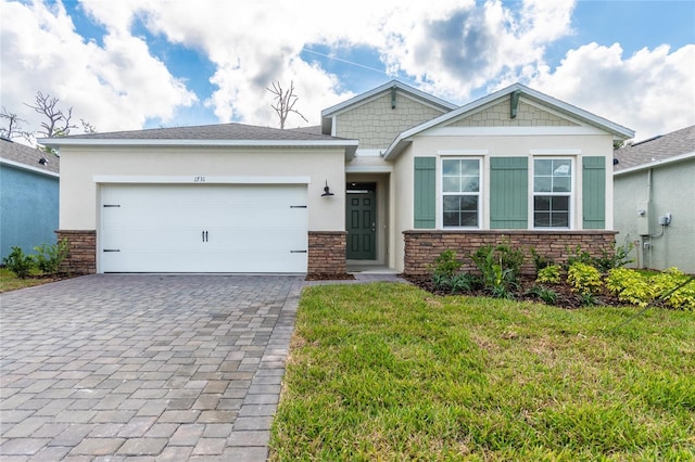 view of front of property featuring a garage and a front lawn