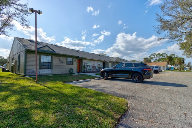 1140 Fairvilla Dr, New Smyrna Beach, FL 32168 - ranch-style home with a front yard