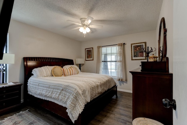 bedroom featuring ceiling fan, dark wood-type flooring, and a textured ceiling