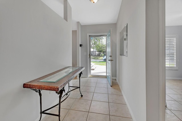 entryway featuring light tile patterned floors and baseboards