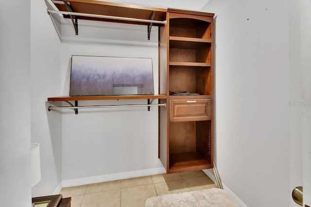 spacious closet with light tile patterned floors