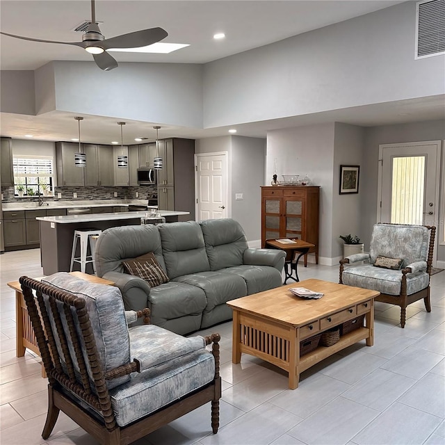 living room with high vaulted ceiling and ceiling fan