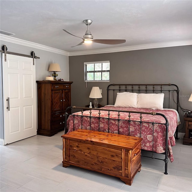 bedroom with ceiling fan, ornamental molding, and a barn door