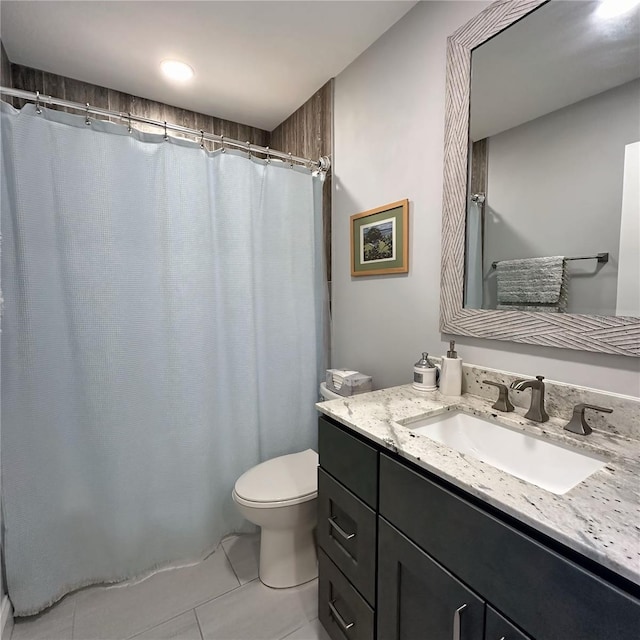 bathroom with vanity, toilet, and tile patterned flooring