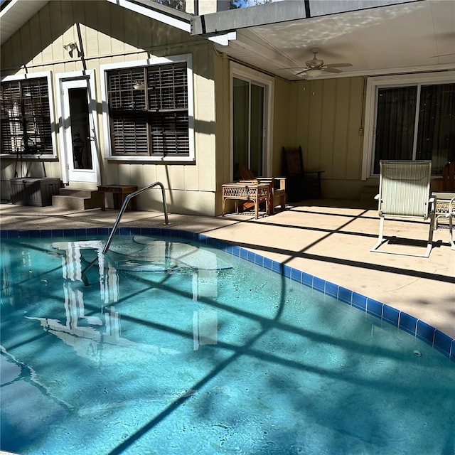 view of pool with ceiling fan and a patio