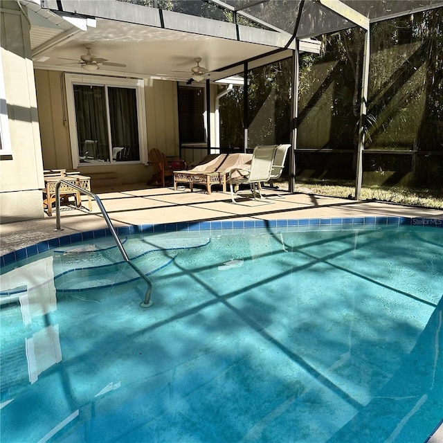 view of pool featuring a patio, ceiling fan, and glass enclosure