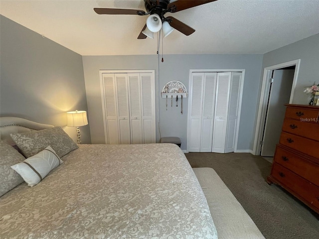 bedroom with two closets, a textured ceiling, ceiling fan, and carpet flooring