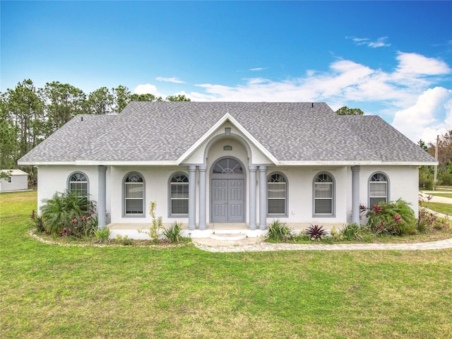 ranch-style home with a front lawn