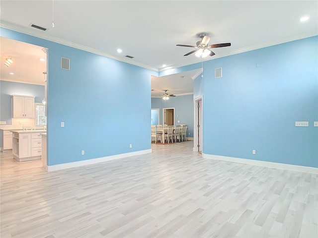 empty room featuring ornamental molding and light hardwood / wood-style flooring