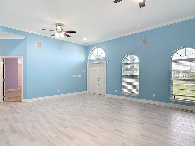 empty room with light hardwood / wood-style flooring, crown molding, a wealth of natural light, and ceiling fan