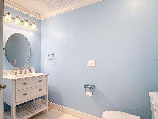 bathroom with vanity, tile patterned floors, ornamental molding, and toilet