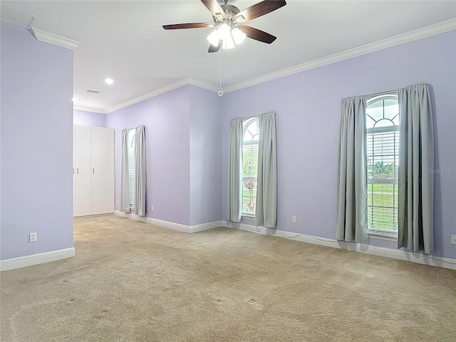 carpeted empty room with crown molding and ceiling fan