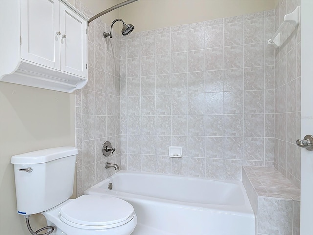 bathroom featuring toilet and tiled shower / bath combo