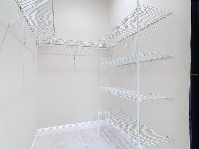 spacious closet with tile patterned flooring