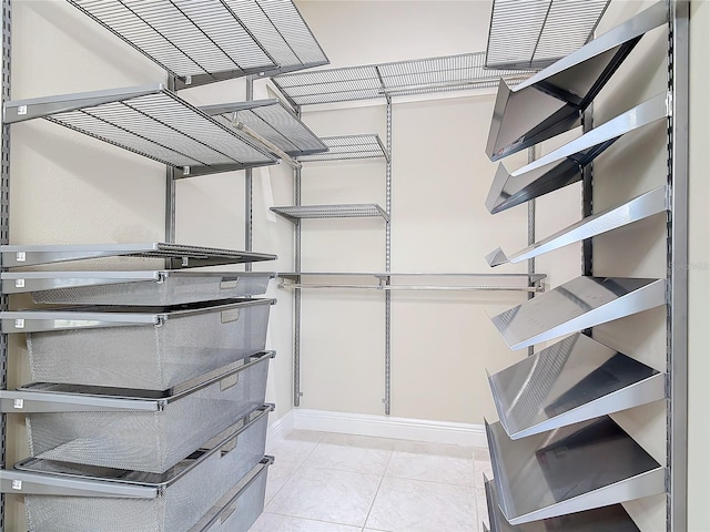 spacious closet featuring light tile patterned floors