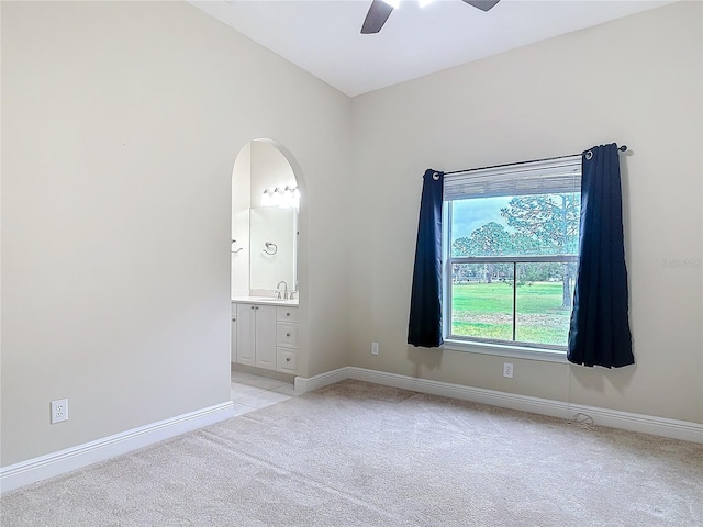 unfurnished room with light carpet and ceiling fan