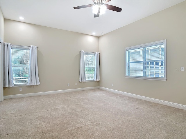unfurnished room with light carpet and ceiling fan