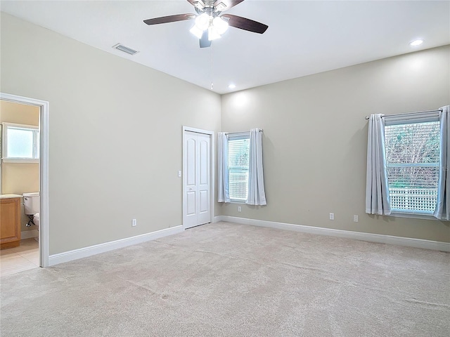 spare room with light colored carpet and ceiling fan