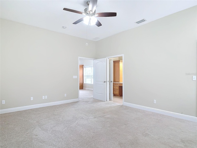 interior space with light carpet and ceiling fan