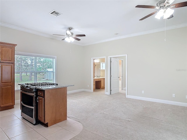kitchen with ceiling fan, ornamental molding, double oven range, and light carpet