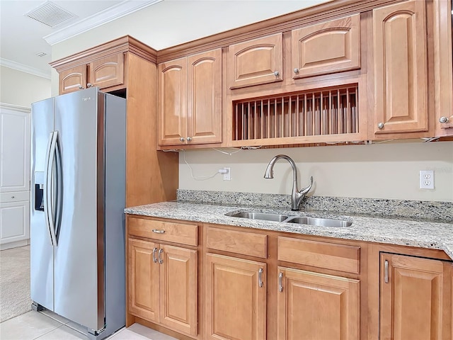 kitchen featuring light stone counters, ornamental molding, sink, and stainless steel fridge with ice dispenser