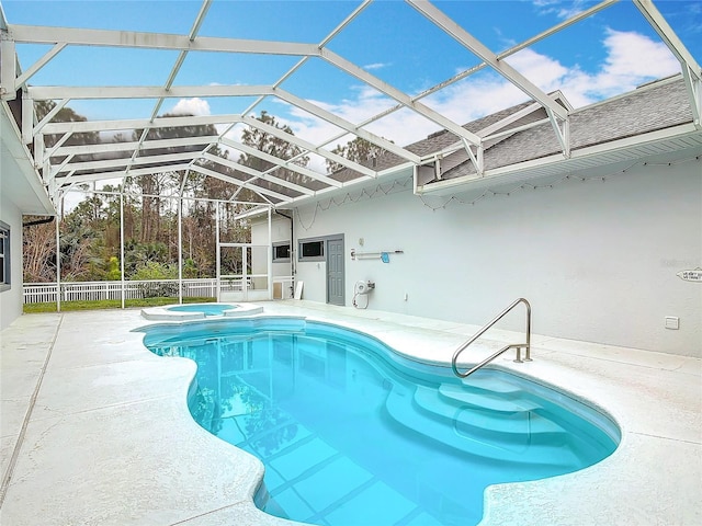view of swimming pool with an in ground hot tub, a lanai, and a patio area