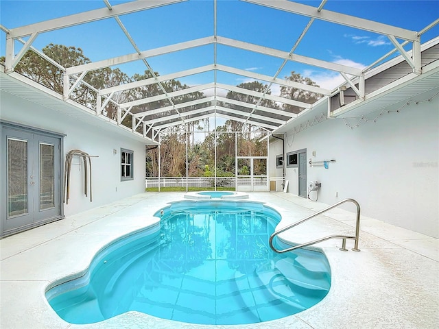 view of swimming pool featuring a patio, an in ground hot tub, french doors, and glass enclosure