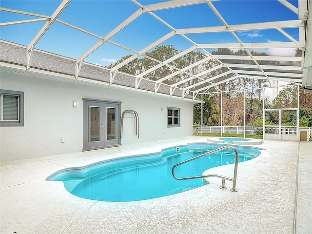 view of swimming pool featuring a patio area, glass enclosure, and french doors