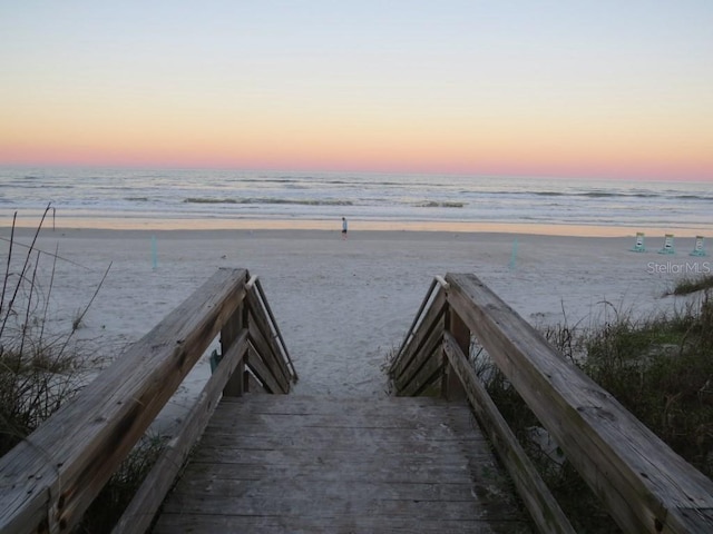 26 Birdie Dr, New Smyrna Beach, FL 32168 - surrounding community with a water view and a view of the beach