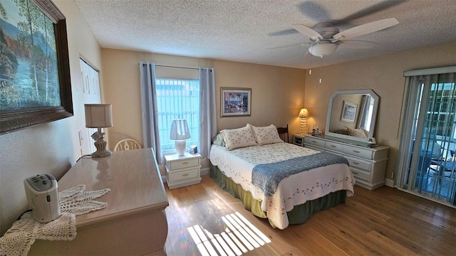 26 Birdie Dr, New Smyrna Beach, FL 32168 - bedroom with ceiling fan, a textured ceiling, and wood finished floors