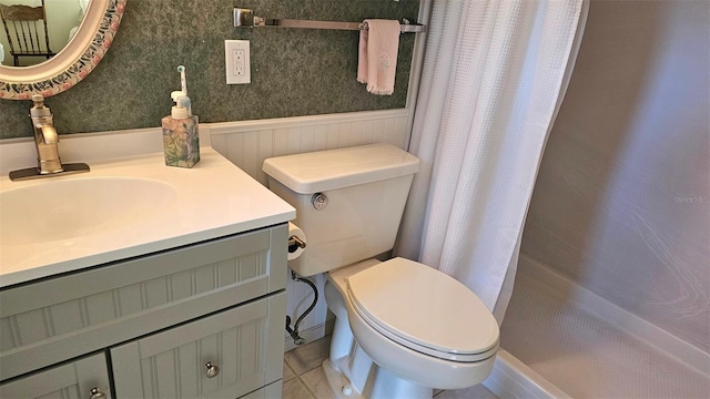 26 Birdie Dr, New Smyrna Beach, FL 32168 - full bath with toilet, vanity, a shower with shower curtain, and wainscoting