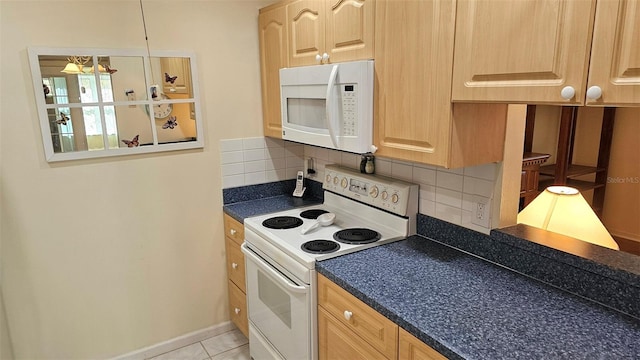 26 Birdie Dr, New Smyrna Beach, FL 32168 - kitchen featuring white appliances, dark countertops, and decorative backsplash