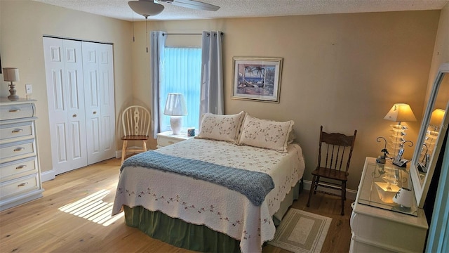 26 Birdie Dr, New Smyrna Beach, FL 32168 - bedroom featuring a textured ceiling, light wood finished floors, and a closet