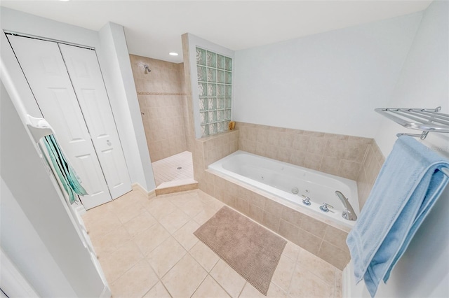 bathroom with tile patterned floors and shower with separate bathtub