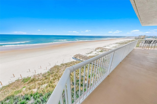 balcony with a water view and a beach view