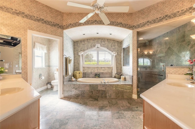 bathroom with a stall shower, wallpapered walls, toilet, a bath, and a sink