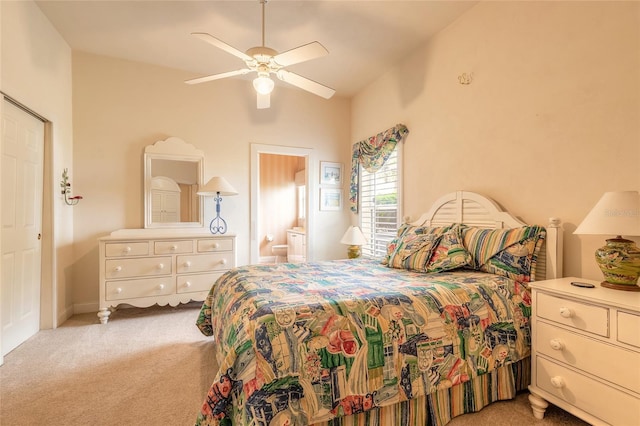 carpeted bedroom with ceiling fan, vaulted ceiling, and connected bathroom