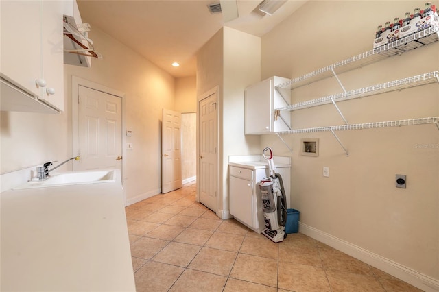 laundry area featuring light tile patterned floors, hookup for a washing machine, cabinet space, hookup for an electric dryer, and a sink