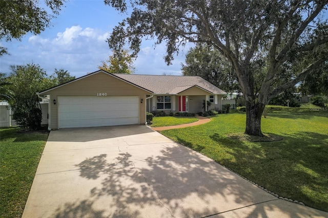 single story home with an attached garage, driveway, and a front lawn