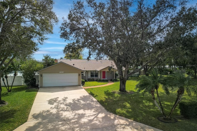 view of front of property with a garage, driveway, a front lawn, and fence