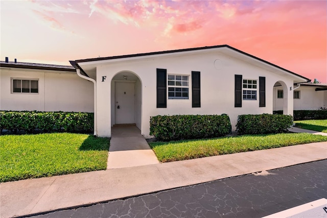 view of front of property with a lawn