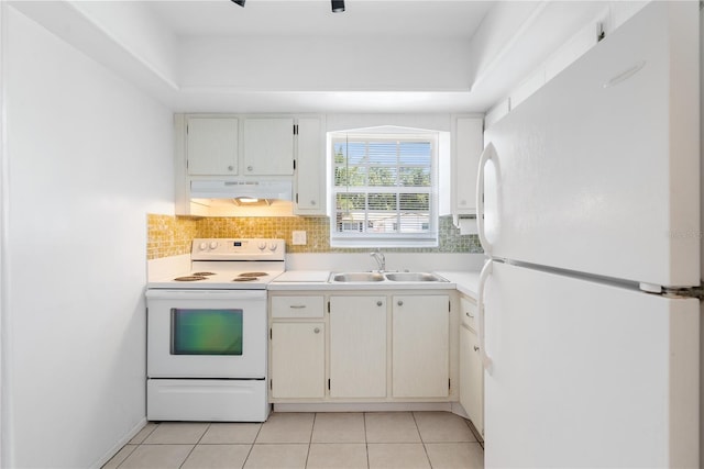 kitchen featuring white appliances, white cabinets, decorative backsplash, light tile patterned floors, and sink