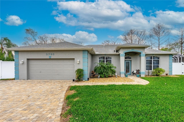 ranch-style home with a garage, fence, decorative driveway, a front lawn, and stucco siding