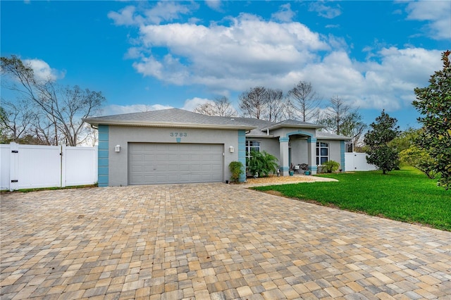 ranch-style house featuring a garage, a front lawn, a gate, and stucco siding