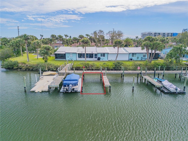 dock area featuring a lawn and a water view