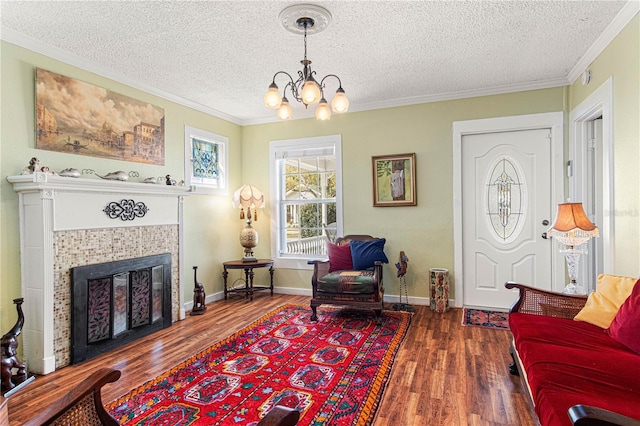 sitting room featuring ornamental molding, dark wood-style flooring, a fireplace, and a textured ceiling